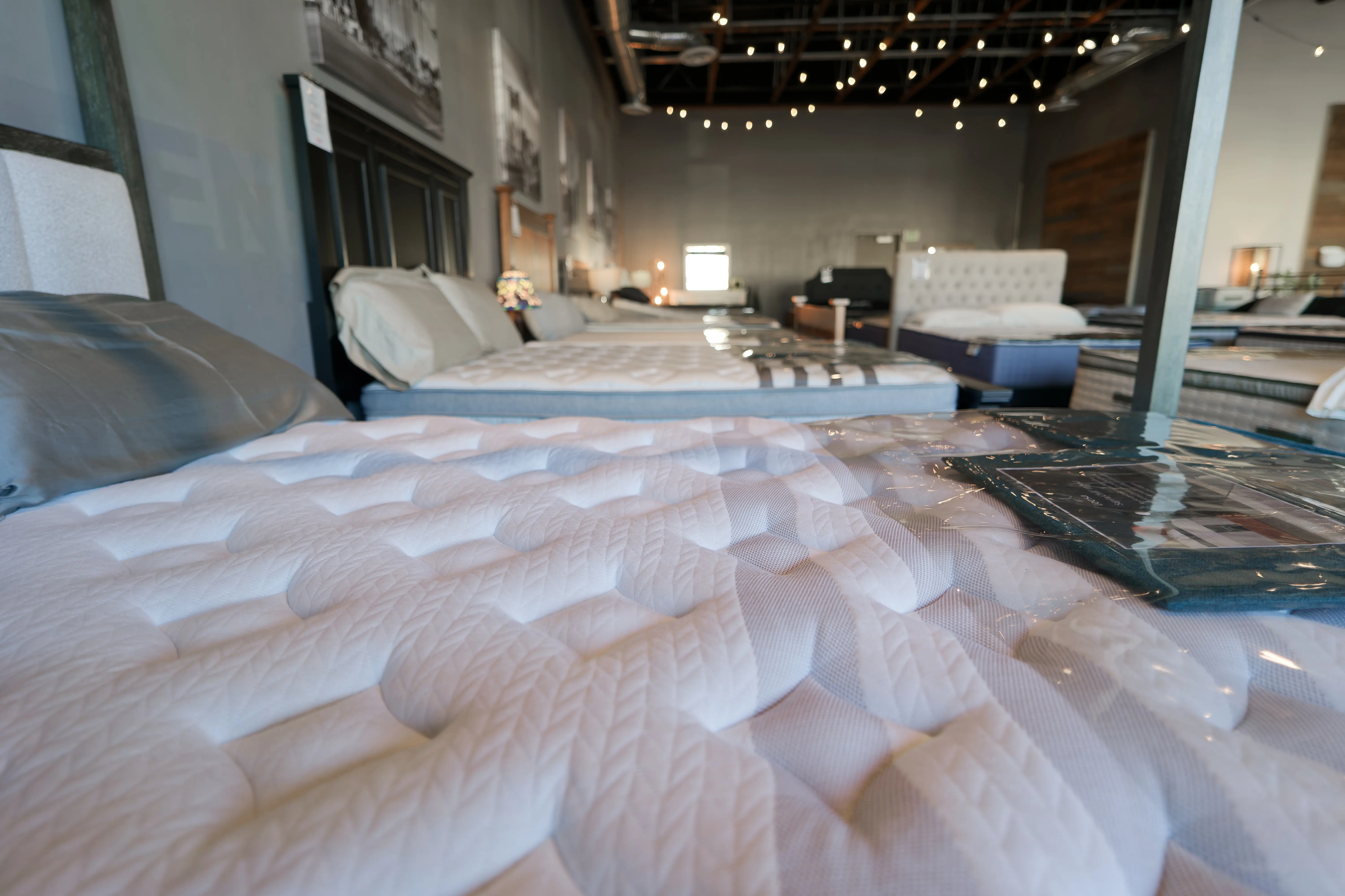 Close-up of white tufted mattress