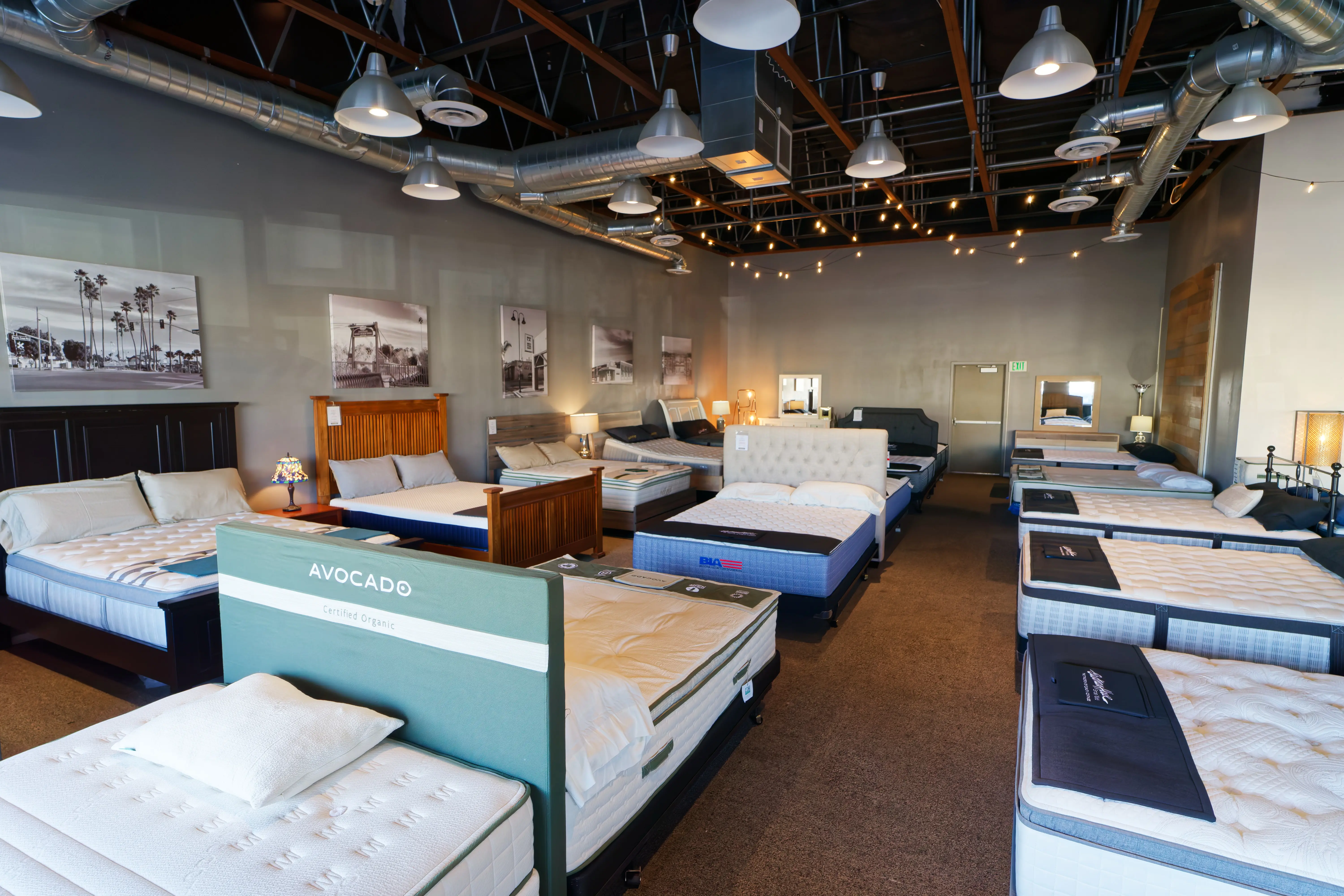 Wide shot of The Mattress Outlet showroom aisle